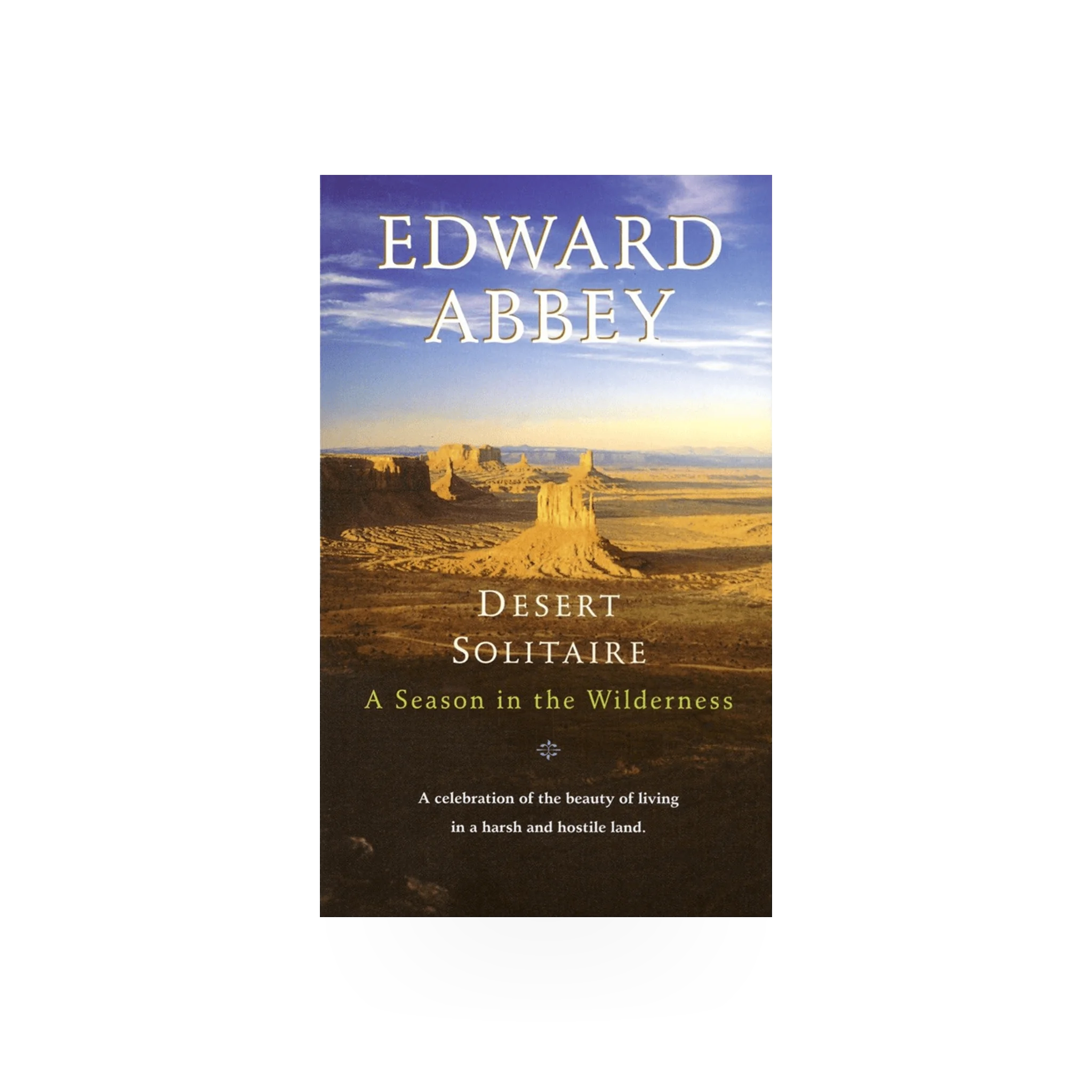 Desert Solitaire book by Penguin Random House, open pages showing text and desert landscape illustration on cover.