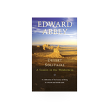 Desert Solitaire book by Penguin Random House, open pages showing text and desert landscape illustration on cover.