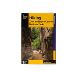 Simon & Schuster book titled "Falcon Hiking Zion & Bryce," featuring a cover image with scenic landscapes and hiking trails.