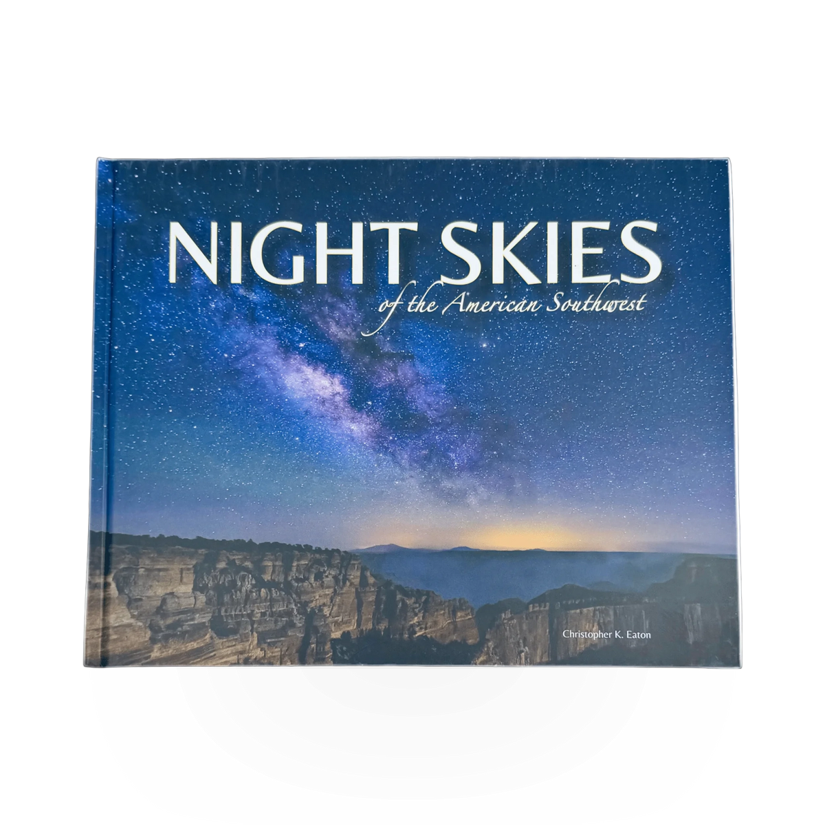 Open book titled "Night Skies of the American Southwest" with starry sky illustrations on pages.