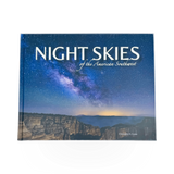 Open book titled "Night Skies of the American Southwest" with starry sky illustrations on pages.
