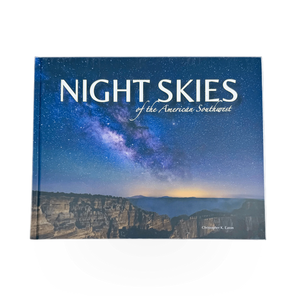Open book titled "Night Skies of the American Southwest" with starry sky illustrations on pages.