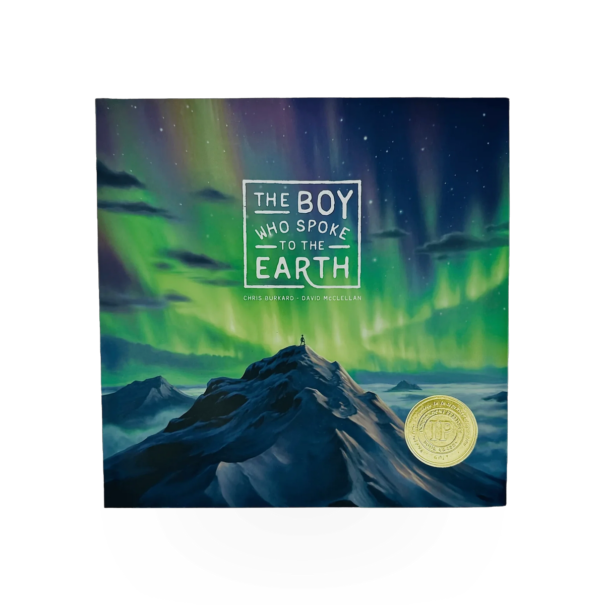 A hardcover copy of "The Boy Who Spoke To The Earth" published by Dreamling Books, featuring a colorful illustrated cover.