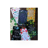 A colorful deck of "How To Be A Wildflower" cards by Chronicle Books, featuring floral illustrations and inspirational messages.
