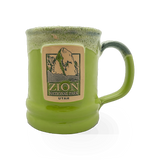 Deneen Pottery Deneen GWT Kiwi themed mug with green kiwi design on white ceramic surface