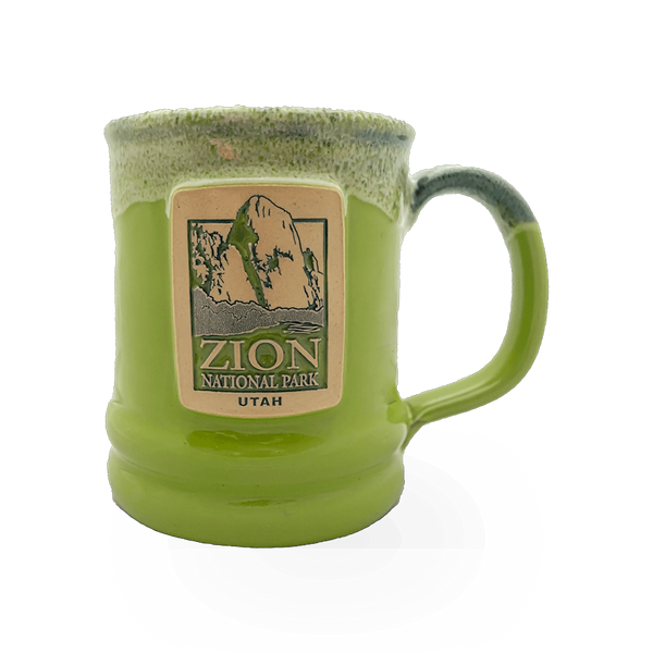 Deneen Pottery Deneen GWT Kiwi theme mug with green and white design, ceramic cup with handle on a plain background.