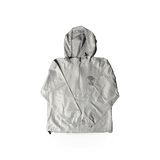 MV Sport Zion packable windbreaker jacket, lightweight and foldable, shown in a compact form ideal for outdoor activities.