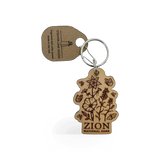 Wood pollinator Zion keychain by Steamer Lane Design, featuring intricate wood craftsmanship and natural botanical details.