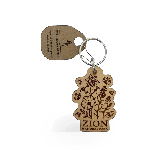Wood pollinator Zion keychain by Steamer Lane Design, featuring intricate wood craftsmanship and natural botanical details.