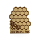 Steamer Lane Design wood honeycomb and bee magnet featuring Zion design, with detailed honeycomb pattern and bee illustration.