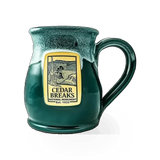 Deneen Pottery Cedar Breaks theme mug featuring a scenic landscape design with earthy tones and detailed illustrations.