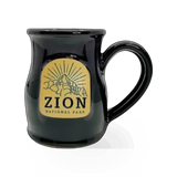 Deneen Pottery Zion Sunburst theme mug with vibrant sunburst design and earthy tones, ceramic handle, on a neutral background