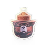 Sticker featuring Smokey Bear's head by Impact Photographics, showcasing a detailed illustration on a durable adhesive backing.